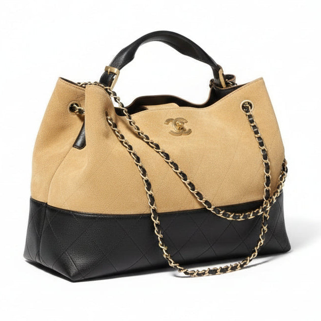 This New, Certified Authentic Chanel 25 Hobo Bag is a rare collector's piece, crafted in sumptuous tan quilted suede and finished with distinctive antique gold hardware.