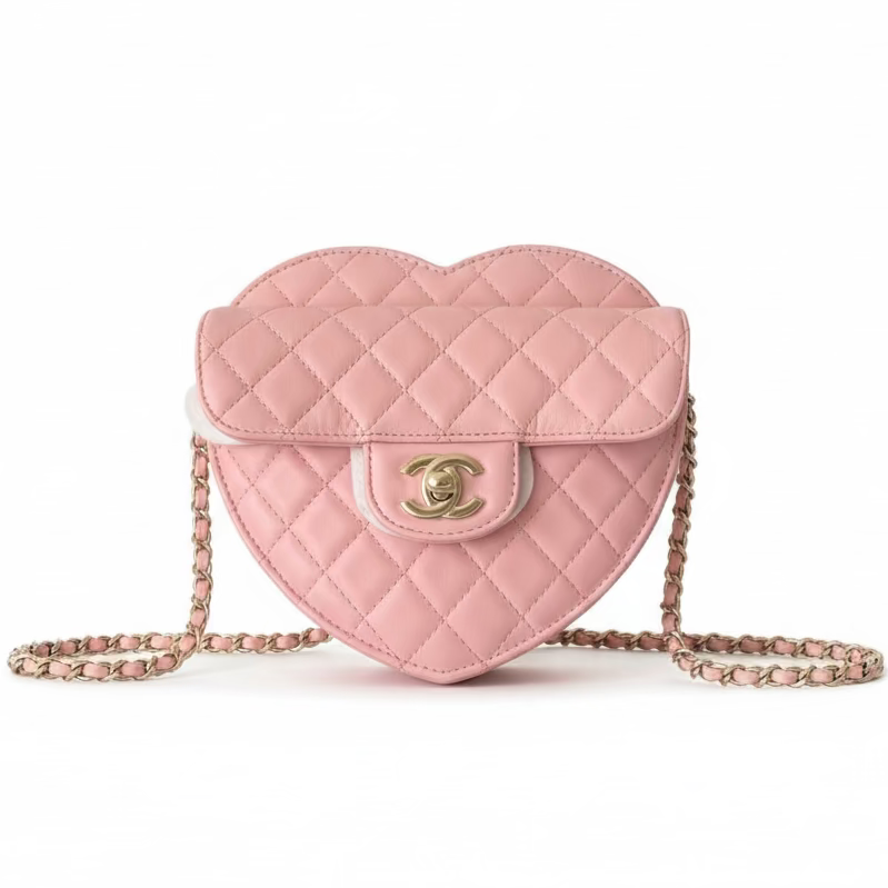 This Certified Authentic Chanel Heart Bag is a charming and distinctive accessory, featuring signature diamond quilting in delicate Light Pink Lambskin and finished with a classic gold-tone 'CC' logo.