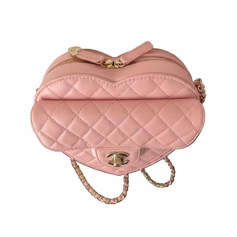 This Certified Authentic Chanel Heart Bag is a charming and distinctive accessory, featuring signature diamond quilting in delicate Light Pink Lambskin and finished with a classic gold-tone 'CC' logo.
