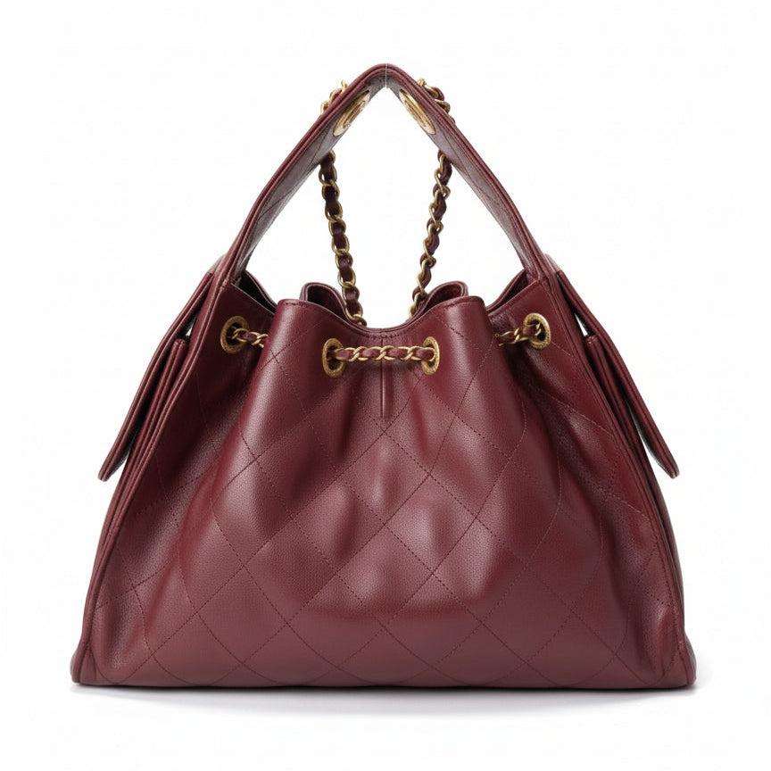 Burgundy Chanel 25 Medium handbag with gold chain and hardware on a white background