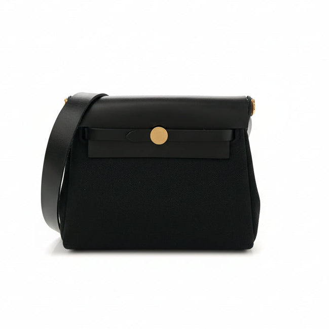 This New, Certified Authentic Hermès Mini Herbag Zip PM is an elegant piece, featuring a black canvas body and leather flap, finished with striking gold-tone hardware (GHW).