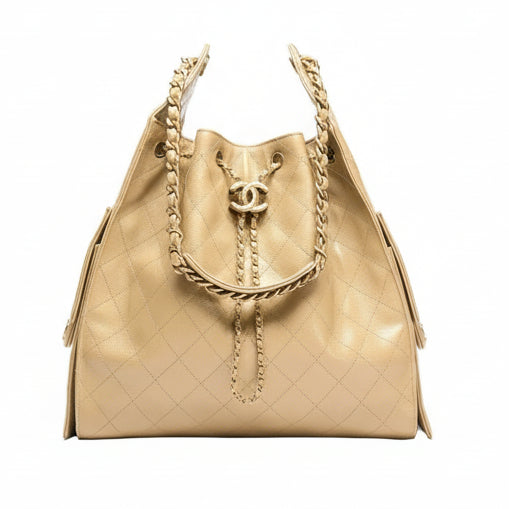 Beige quilted Chanel 25 handbag with gold chain detail on a white background