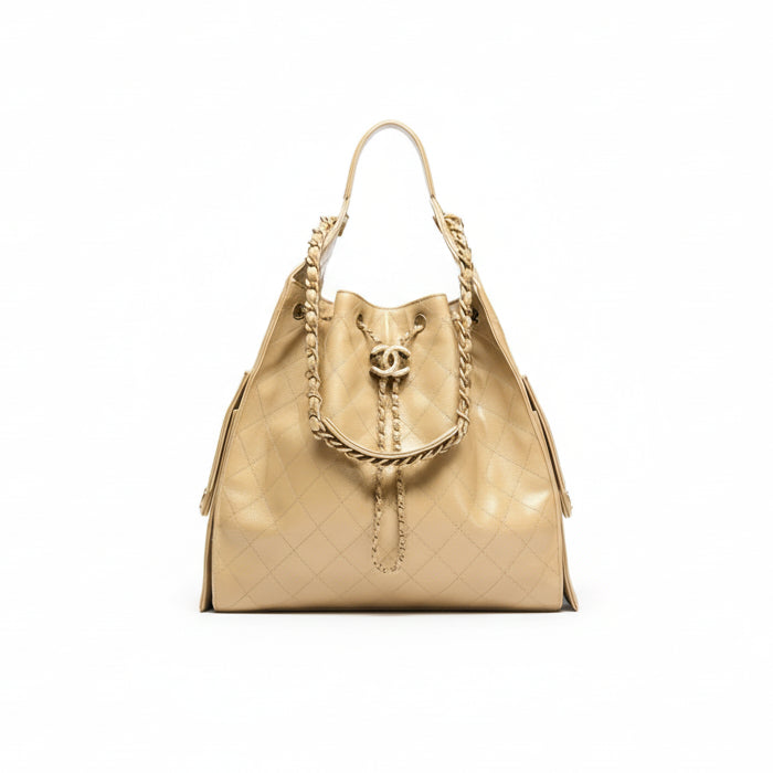 Beige quilted Chanel 25 handbag with gold chain detail on a white background