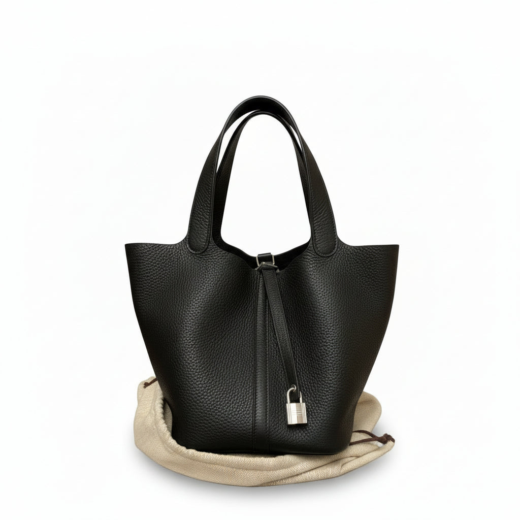 This Brand New, Certified Hermès Picotin 22 is a highly sought-after 2025 collection piece. Crafted in elegant Noir (Black) Swift leather and finished with Palladium Hardware (PHW), this chic bucket bag is a timeless luxury asset.