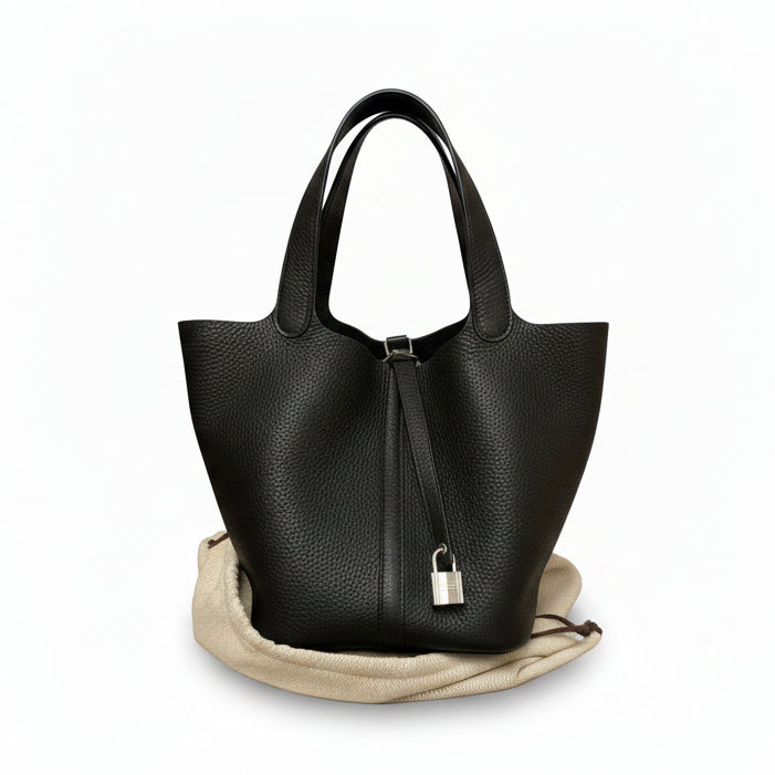 This Brand New, Certified Hermès Picotin 22 is a highly sought-after 2025 collection piece. Crafted in elegant Noir (Black) Swift leather and finished with Palladium Hardware (PHW), this chic bucket bag is a timeless luxury asset.