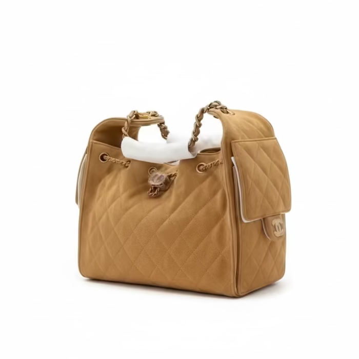 This New, Certified Authentic Chanel 25 Small Hobo Bag is a luxurious and distinctive piece, rendered in soft camel tan quilted suede leather and accented with desirable gold-tone chain and GHW (Gold Hardware).
