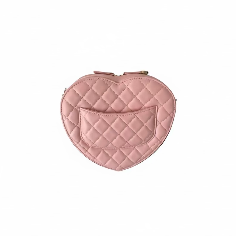 This Certified Authentic Chanel Heart Bag is a charming and distinctive accessory, featuring signature diamond quilting in delicate Light Pink Lambskin and finished with a classic gold-tone 'CC' logo.