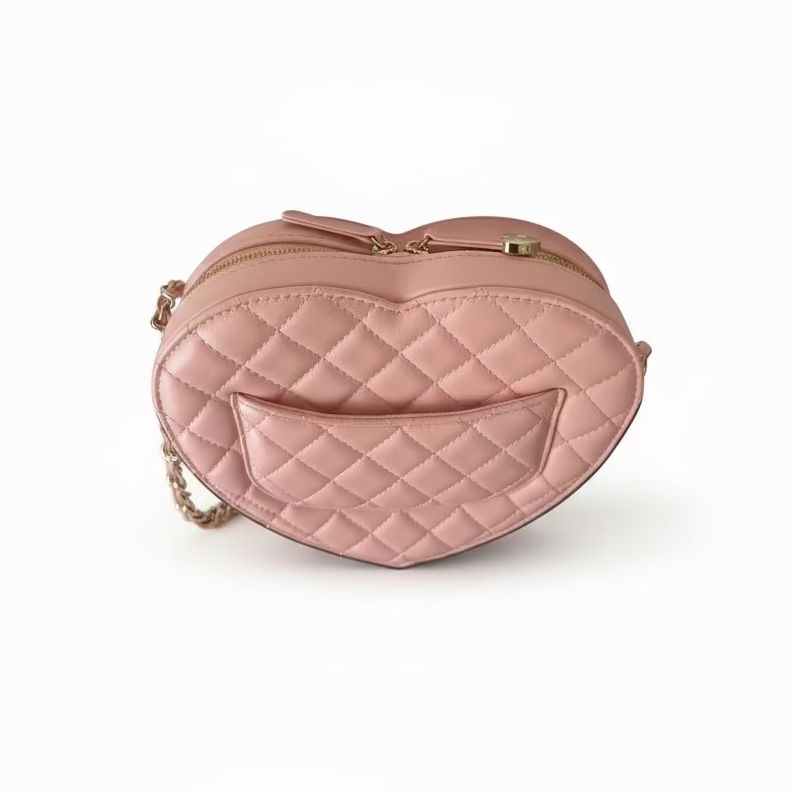 This Certified Authentic Chanel Heart Bag is a charming and distinctive accessory, featuring signature diamond quilting in delicate Light Pink Lambskin and finished with a classic gold-tone 'CC' logo.