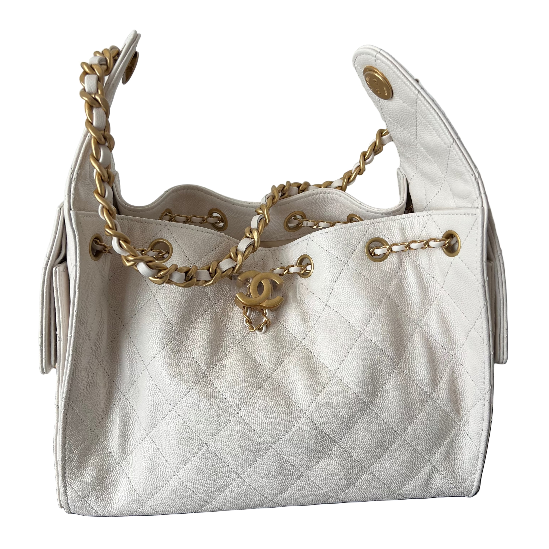 White Chanel 25 small quilted handbag with gold chain and CC logo on a white background